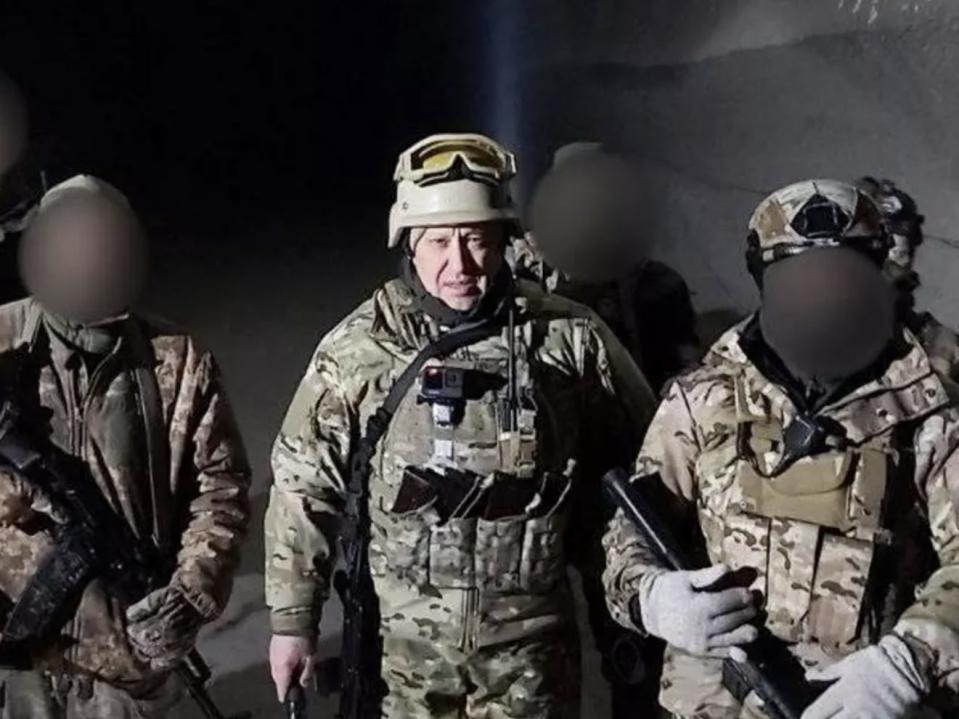 Wagner Group chief Yevgeny Prigozhin in military gear with several others, whose faces have been blurred, in what Russian state media described as the salt mines of Soledar, eastern Ukraine, on January 10 2022.