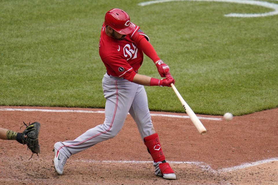 Cincinnati Reds' Eugenio Suarez hits a double off Pittsburgh Pirates relief pitcher Duane Underwood Jr., driving in three runs during the tenth inning of a baseball game in Pittsburgh, Wednesday, May 12, 2021.(AP Photo/Gene J. Puskar)