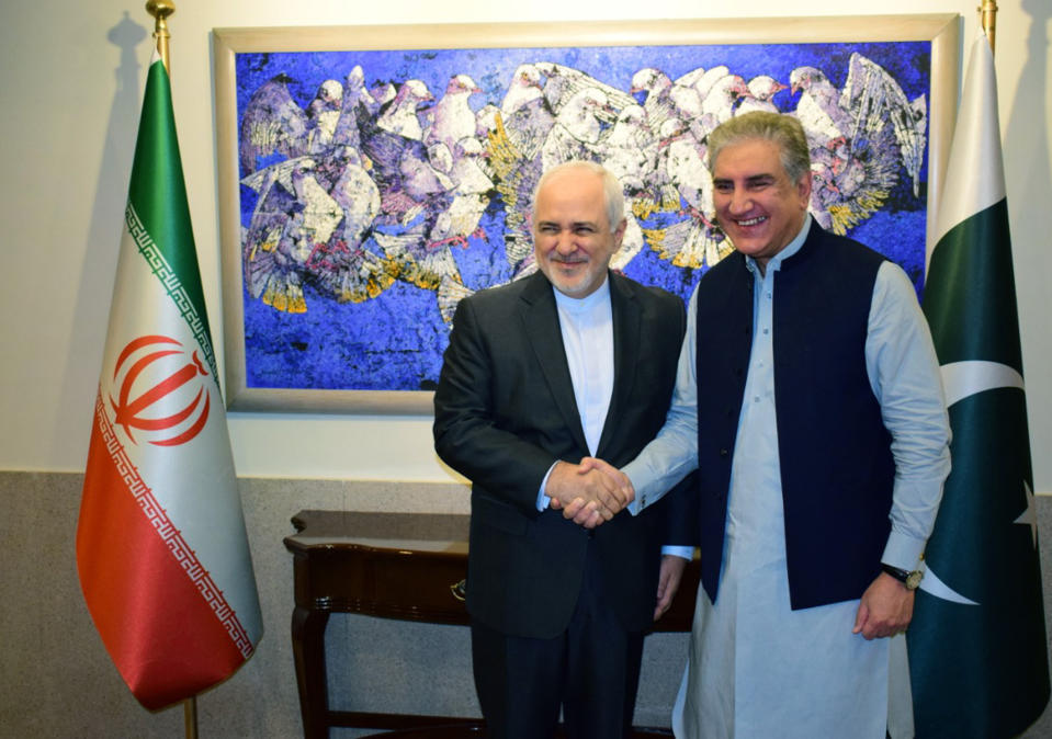 In this photo released by the Foreign Office, Iranian Foreign Minister Mohammad Javad Zarif, left, shakes hands with his Pakistani counterpart Shah Mehmood Qureshi at the Foreign Ministry in Islamabad, Pakistan, Friday, May 24, 2019. Zarif is in Pakistan Friday on a critically timed visit amid a crisis between Tehran and Washington and ahead of next week's emergency Arab League meeting called by Saudi Arabia as regional tensions escalate. (Pakistan Foreign Office via AP)