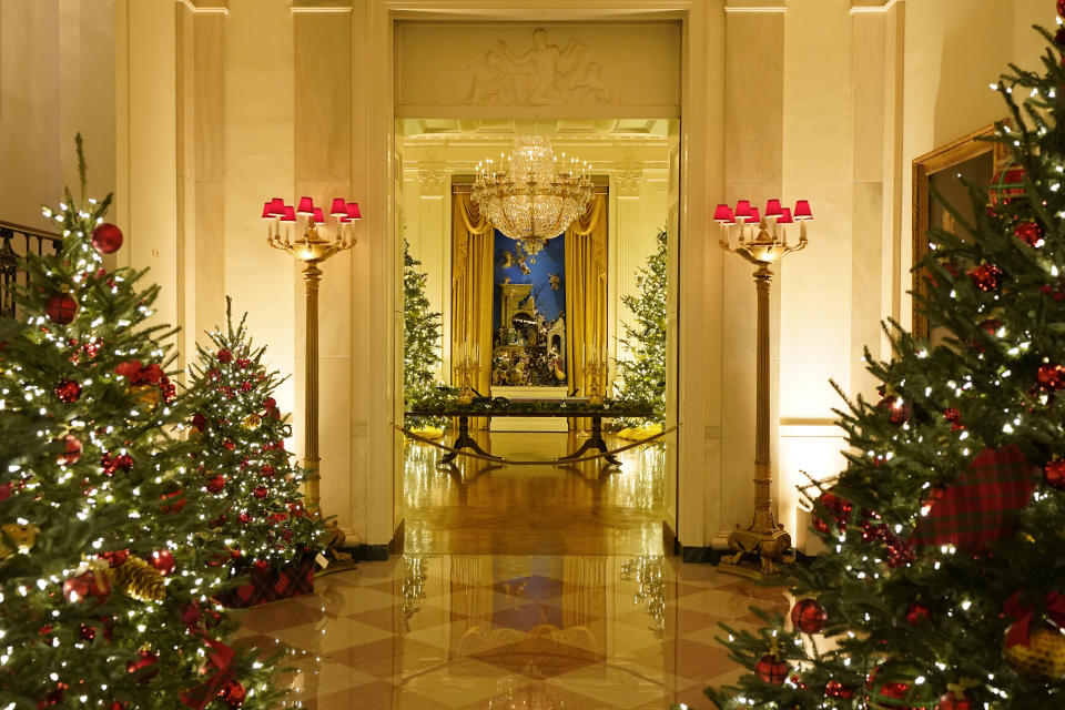 The Cross Hall leading to the East Room of the White House is decorated during the 2020 Christmas preview, Monday, Nov. 30, 2020, in Washington. (AP Photo/Patrick Semansky)