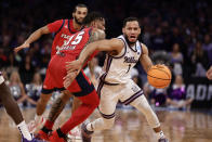 Kansas State's Markquis Nowell (1) arrives against Florida Atlantic's Alijah Martin (15) in the first half of an Elite 8 college basketball game in the NCAA Tournament's East Region final, Saturday, March 25, 2023, in New York. (AP Photo/Adam Hunger)