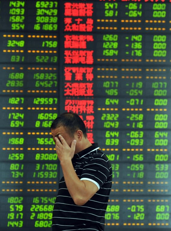 An investor reacts in front of a screen showing stock market movements in Fuyang, eastern China's Anhui province, July 7, 2015