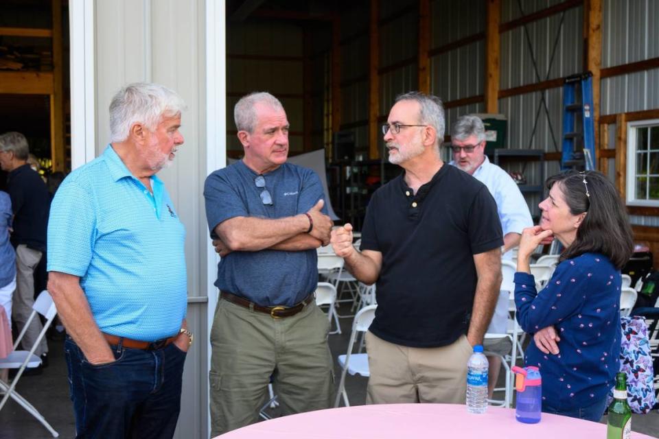 Gene Stocker, left, and Centre County Commissioner Steve Dershem, second from left, listen to residents during a neighborhood meeting in June to discuss PFAS, or “forever chemicals,” water contamination.