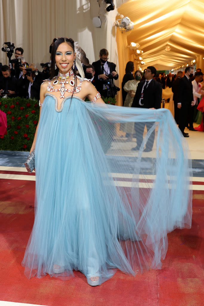 Quannah Chasinghorse in a sheer mesh gown with Native American jewelry