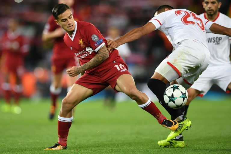 Liverpool midfielder Philippe Coutinho (L) vies with Sevilla defender Gabriel Mercado during the UEFA Champions League Group E football match between Liverpool and Sevilla at Anfield in Liverpool, north-west England on September 13, 2017