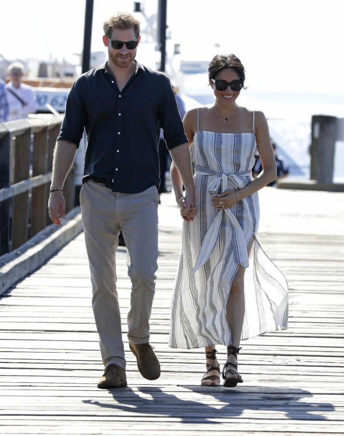 Britain's Prince Harry and Meghan, Duchess of Sussex walk along Kingfisher Bay Jetty during a visit to Fraser Island, Australia, Monday, Oct. 22, 2018. Prince Harry and his wife Meghan are on day seven of their 16-day tour of Australia and the South Pacific. (AP Photo/Kirsty Wigglesworth, Pool)