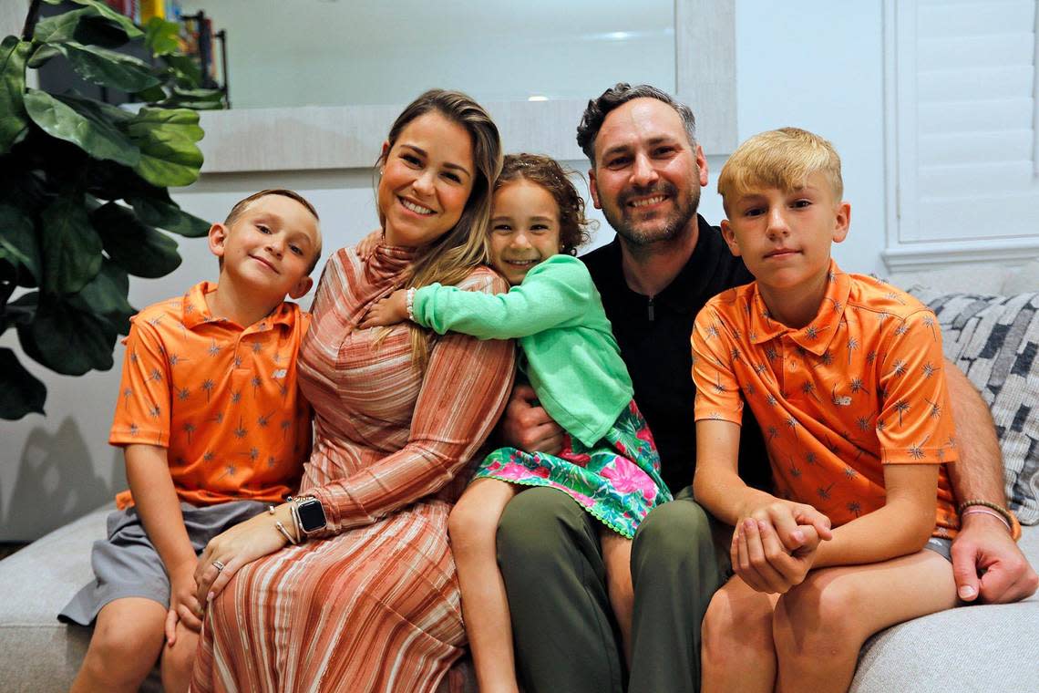 Logan Jenner, 8, former cancer patient at Nicklaus Children’s Hospital next to his family (L to R) Diana Jenner,mom, 35; Mary, sister, 4; Michael Jenner, dad, 38; Ashton, brother, 10; in his house during dinnertime in Miami-Dade on Monday March 4, 2024. Logan has been cancer-free for more than two years. Alexia Fodere/for The Miami Herald