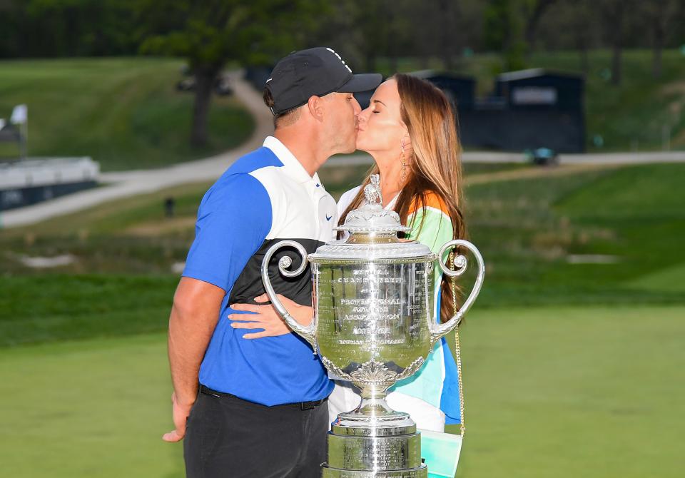 FARMINGDALE, NEW YORK - MAY 19: Brooks Koepka of the United States poses with girlfriend Jena Sims and the Wanamaker Trophy during the Trophy Presentation Ceremony after winning the final round of the 2019 PGA Championship at the Bethpage Black course on May 19, 2019 in Farmingdale, New York. (Photo by Ross Kinnaird/Getty Images)