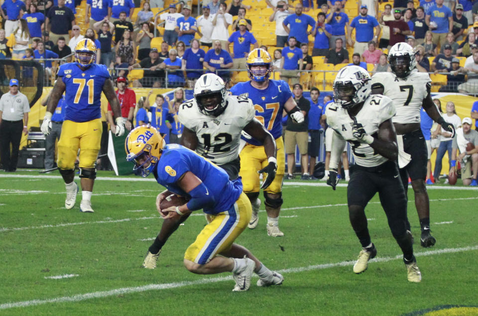 Sep 21, 2019; Pittsburgh, PA, USA;  Pittsburgh Panthers quarterback Kenny Pickett (8) catches a four yard game winning touchdown on a trick play behind UCF Knights linebacker Eric Mitchell (12) during the fourth quarter at Heinz Field. Pittsburgh won 35-34. Mandatory Credit: Charles LeClaire-USA TODAY Sports