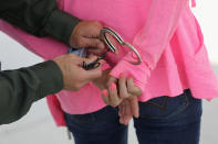 <p>A new U.S. Border Patrol agent handcuffs a woman during a training scenario at the Border Patrol Academy on August 2, 2017 in Artesia, N.M. (Photo: John Moore/Getty Images) </p>