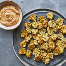 <p>Use your air fryer to make these crispy, salty pickle chips for game day! The air fryer gives you a crispy crust, using much less oil than a traditional fryer. Enjoy these addictive little snacks on their own or with our Southern smoky, creamy dipping sauce. <a href="https://www.eatingwell.com/recipe/278379/crispy-air-fryer-pickle-chips/" rel="nofollow noopener" target="_blank" data-ylk="slk:View Recipe;elm:context_link;itc:0" class="link ">View Recipe</a></p>