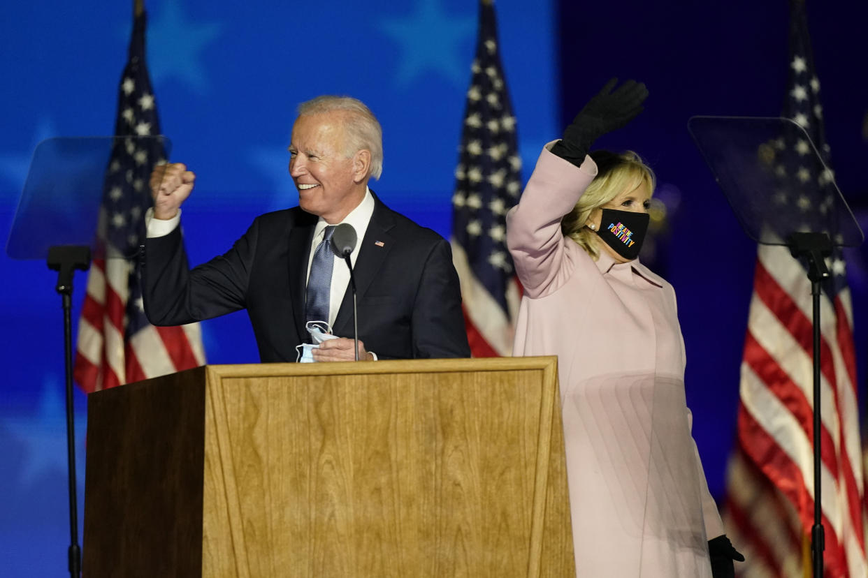 Democratic presidential candidate former Vice President Joe Biden gestures while speaking speaks to supporters, as he stands on stage with his wife Jill Biden Wednesday, Nov. 4, 2020, in Wilmington, Del. (AP Photo/Andrew Harnik)