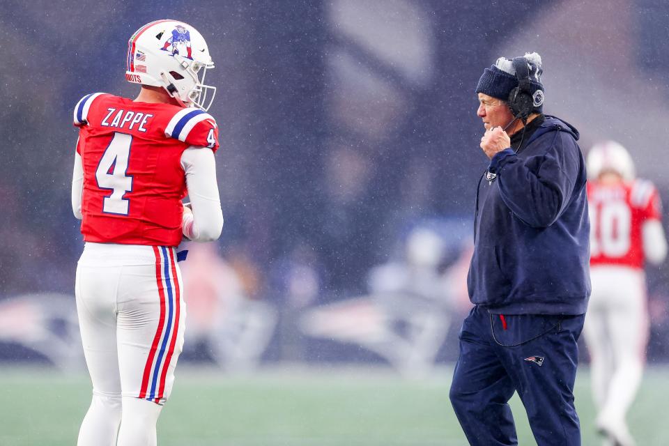FOXBOROUGH, MASSACHUSETTS - DECEMBER 03: Bailey Zappe #4 of the New England Patriots meets with head coach Bill Belichick in the third quarter against the Los Angeles Chargers at Gillette Stadium on December 03, 2023 in Foxborough, Massachusetts. (Photo by Maddie Meyer/Getty Images)