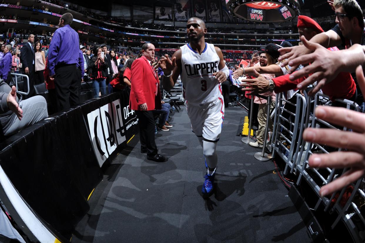 Chris Paul shakes hands with fans at Staples Center after a game against the New York Knicks on March 11, 2016. (Getty Images)