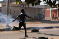 A protester runs at a demonstration, in Khartoum, Sudan, Wednesday, Oct. 21, 2020. Protesters have taken to the streets in the capital and across the country over dire living conditions and a deadly crackdown on demonstrators in the east earlier this month. Sudan is currently ruled by a joint civilian-military government, following the popular uprising that toppled longtime autocrat Omar al-Bashir last year. (AP Photo/Marwan Ali)