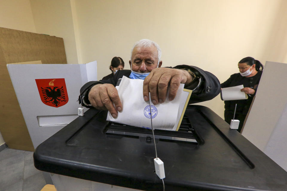 A man casts his ballot during parliamentary elections in Tirana, Sunday, April 25, 2021. Albanians are voting in parliamentary elections on Sunday amid the virus pandemic and a bitter rivalry between the two largest political parties. (AP Photo/Hektor Pustina)