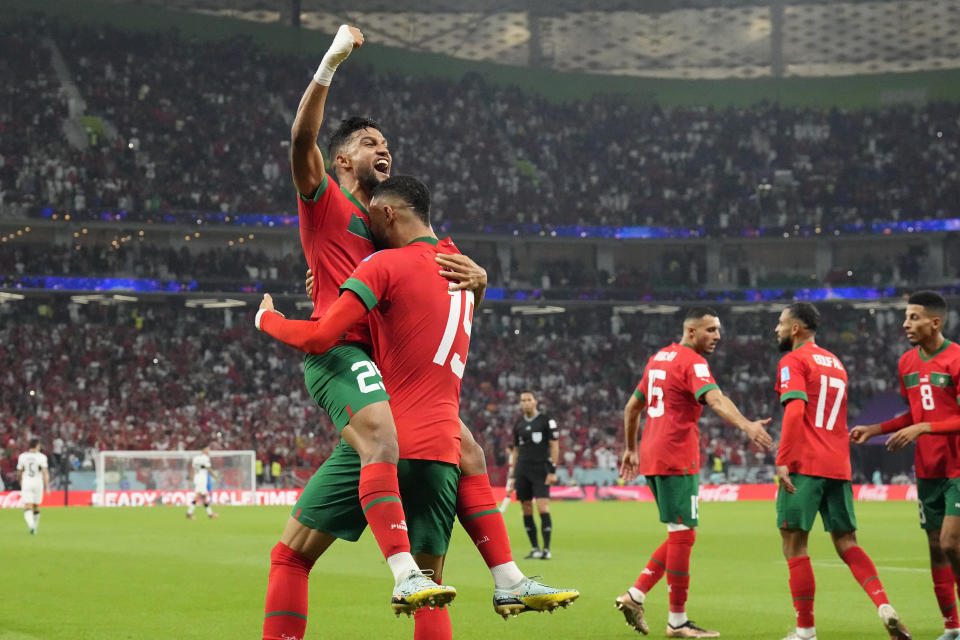 Morocco's Youssef En-Nesyri, right, celebrates after scoring his side's first goal during the World Cup quarterfinal soccer match between Morocco and Portugal, at Al Thumama Stadium in Doha, Qatar, Saturday, Dec. 10, 2022. (AP Photo/Martin Meissner)