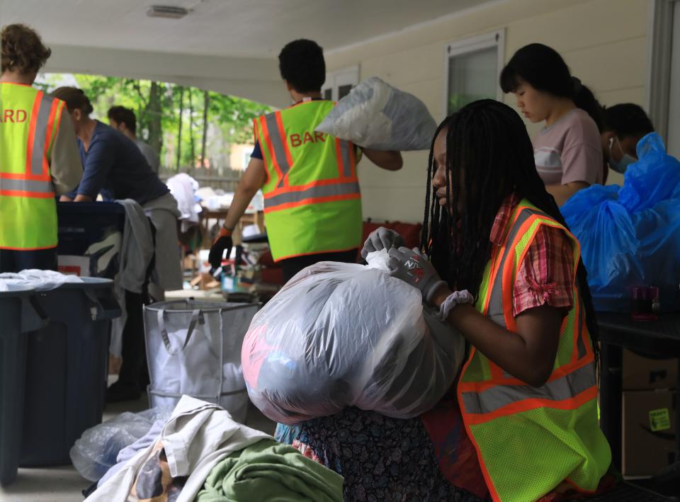 Bard College incoming sophomore Precious Star from Wanaque, New Jersey bags up clothing that has been sorted for Bard's Free-Use Store on May 26, 2022.  As students move out of campus Free-Use Store staff placed collection bins outside dormitories for students to donate useable items. 