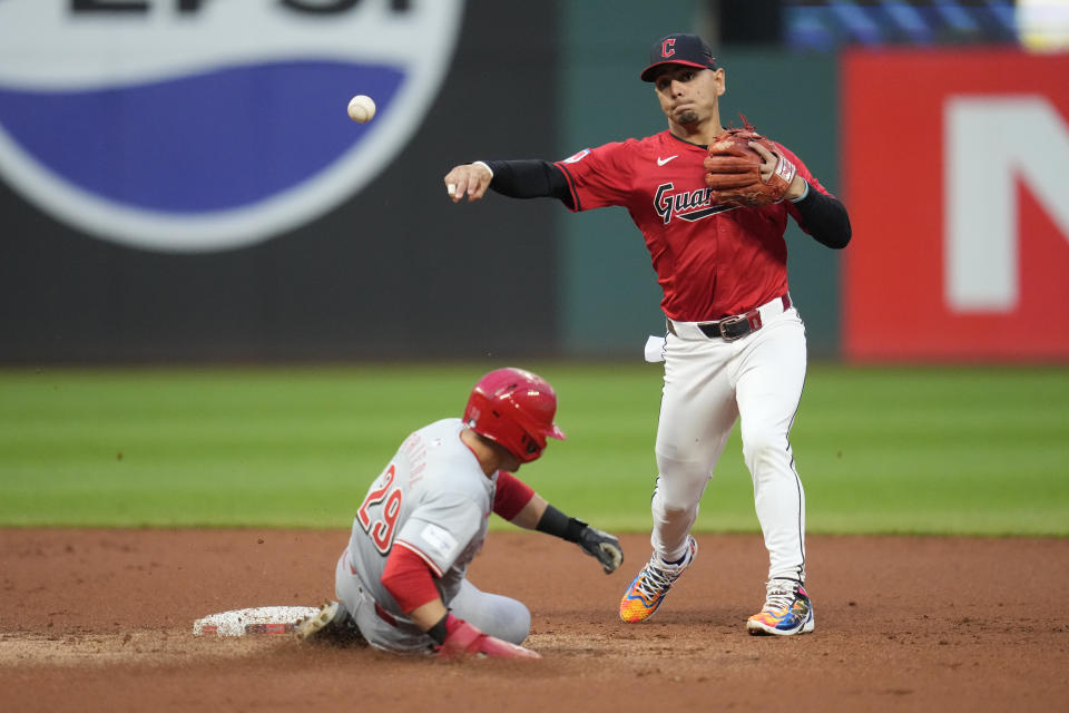 Cleveland Guardians second baseman Andres Gimenez, right, forces out Cincinnati Reds' TJ Friedl, left, at second base and completes the throw for the out on Ty France for a double play in the second inning of a baseball game in Cleveland, Tuesday, Sept. 24, 2024. (AP Photo/Sue Ogrocki)