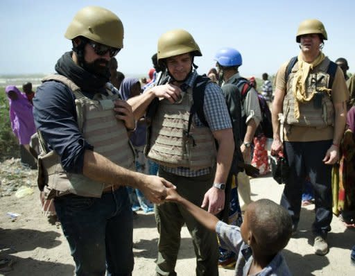 Russia's Evgeny Lebedev (L), seen here meeting a young internally-displaced person at a camp in Somalia's war-shattered capital Mogadishu on February 13. Lebedev is the son of Russian oligarch Alexander Lebedev and a British press baron