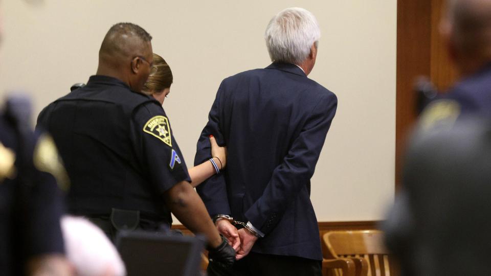 James Krauseneck is led away in handcuffs after he was found guilty for the 1982 murder of his first wife Cathy in Brighton, New York. / Credit: Jamie Germano