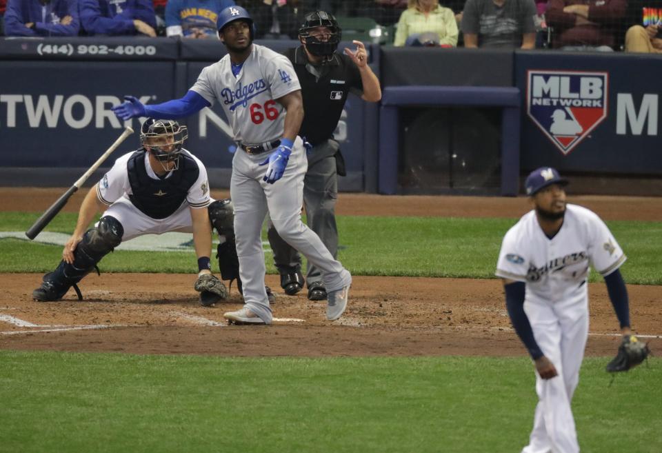 Los Angeles Dodgers right fielder Yasiel Puig (66) hits a three-run homer during the sixth inning of their National League Championship Series baseball game against the Milwaukee Brewers  Saturday, October 20, 2018 at Miller Park in Milwaukee, Wis.