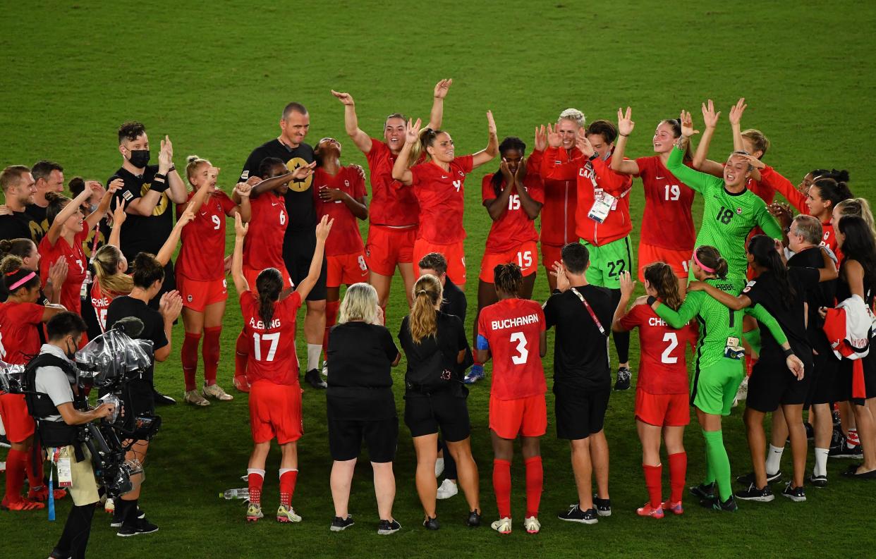 Canada's players celebrate winning the gold medal after the penalty shoot-out of the Tokyo 2020 Olympic Games women's final football match between Sweden and Canada at the International Stadium Yokohama in Yokohama on August 6, 2021. (Photo by Tiziana FABI / AFP) (Photo by TIZIANA FABI/AFP via Getty Images)