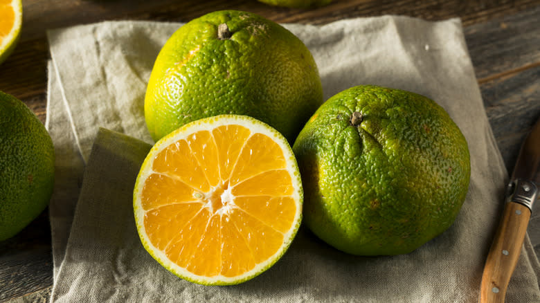 Ugli fruits on wood board