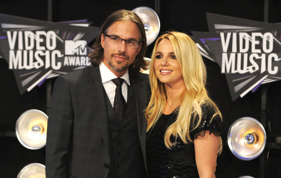 FILE - In this Aug. 28, 2011 file photo, Jason Trawick and Britney Spears arrive at the MTV Video Music Awards in Los Angeles. A judge says Spears' one-time fiance Jason Trawick has resigned as her co-conservator on Friday Jan. 11, 2013. (AP Photo/Chris Pizzello, file)