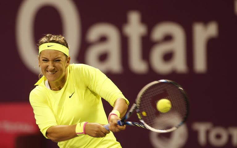 Victoria Azarenka of Belarus returns the ball to Lucie Safarova of the Czech Republic in the final of the women's singles Qatar Open tennis tournament on February 28, 2015 in Doha