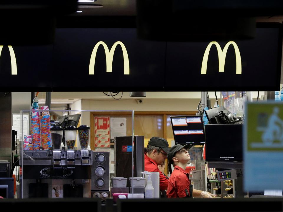 Fast food restaurant workers prepare food for drive through customers as level four COVID 19 restrictions are eased in Christchurch, New Zealand, on April 27, 2020.