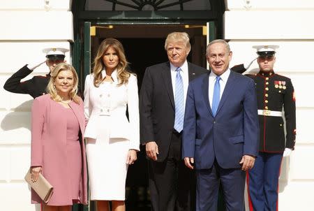 U.S. President Donald Trump (2ndR) and first lady Melania Trump greet Israeli Prime Minister Benjamin Netanyahu and his wife Sara (L) as they arrive at the South Portico of the White House in Washington, U.S., February 15, 2017. REUTERS/Kevin Lamarque