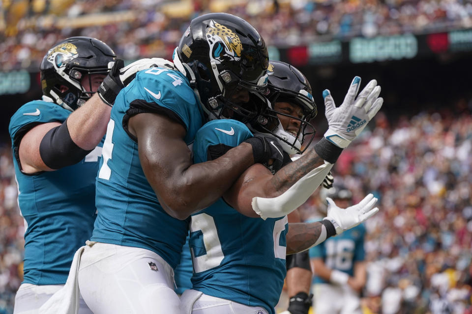 Jacksonville Jaguars running back James Robinson (25) celebrating his touchdown with teammates during the second half of an NFL football game against the Washington Commanders, Sunday, Sept. 11, 2022, in Landover, Md. (AP Photo/Patrick Semansky)