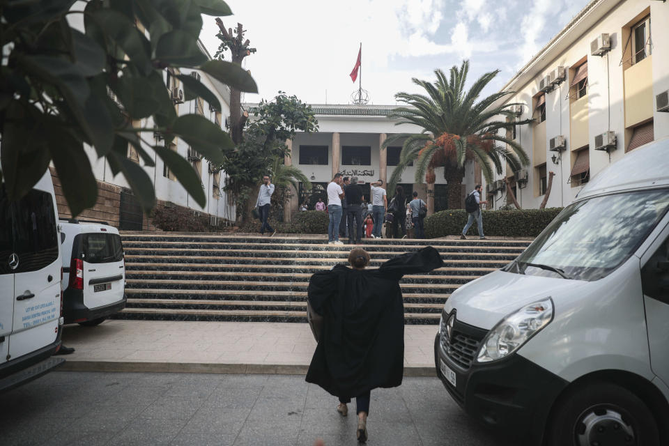 A lawyer walks outside the court where journalist Hajar Rissouni is being tried on accusations of undergoing an illegal abortion, in Rabat, Morocco, Monday, Sept. 30, 2019. The 28-year old Moroccan journalist Hajar Raissouni was sentenced to one year in prison, while her fiancé also received a one-year sentence and the doctor accused of terminating the pregnancy was sentenced to two years in jail and suspended from practicing. (AP Photo/Mosa'ab Elshamy)