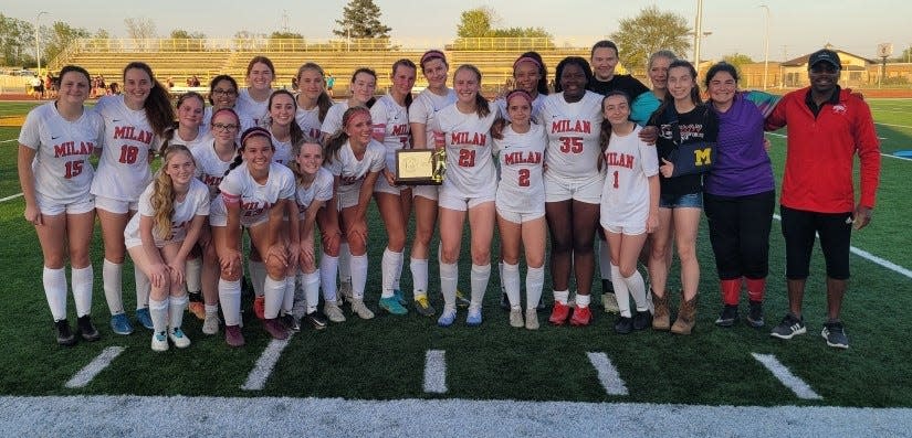 Milan's girls soccer team poses with the championship trophy after wrapping up the Huron League championship Thursday.