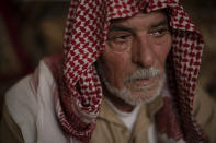 In this April 14, 2019 photo, Hussein Abd cries while talking about the death of his three sons as he sits in his house in Mosul, Iraq. They were killed in Badoush by Islamic State militants in a January attack. (AP Photo/Felipe Dana)