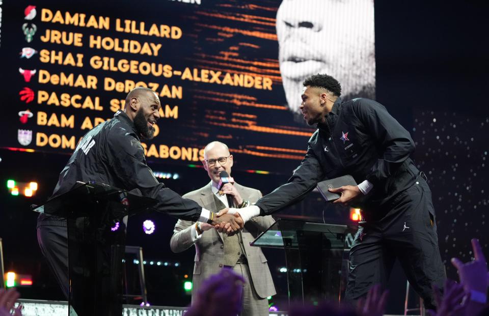 LeBron James, left, shakes hands with Giannis Antetokounmpo after the two captains completed the draft before the 2023 NBA All-Star Game in Salt Lake City.