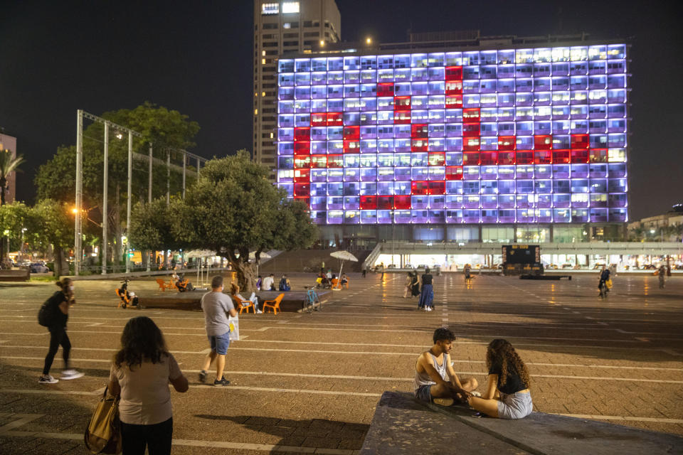 Tel Aviv City Hall is lit up with the words for peace in Hebrew, Arabic and English in honor of the recognition agreements Israel will be signing with the United Arab Emirates and Bahrain at the White House, in Tel Aviv, Israel, Tuesday, Sept. 15, 2020. (AP Photo/Oded Balilty)