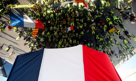 Protesters are reflected on large mirror panels as they take part in a demonstration of the "yellow vests" movement in Marseille, France, January 19, 2019. REUTERS/Jean-Paul Pelissier