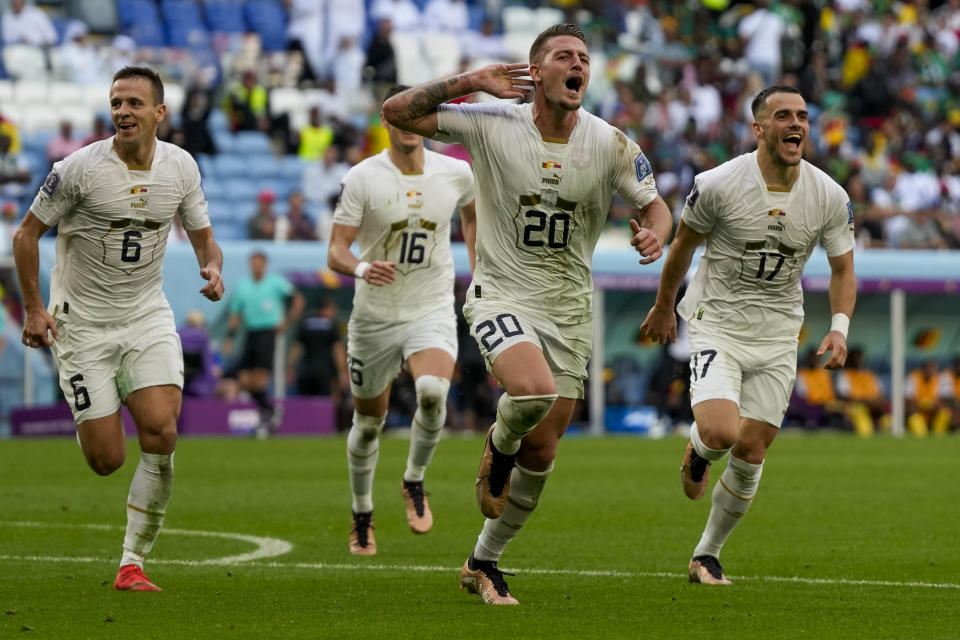 Serbia's Sergej Milinkovic-Savic, left, celebrates after scoring his side's second goal during the World Cup group G soccer match between Cameroon and Serbia, at the Al Janoub Stadium in Al Wakrah, Qatar, Monday, Nov. 28, 2022. (AP Photo/Frank Augstein)