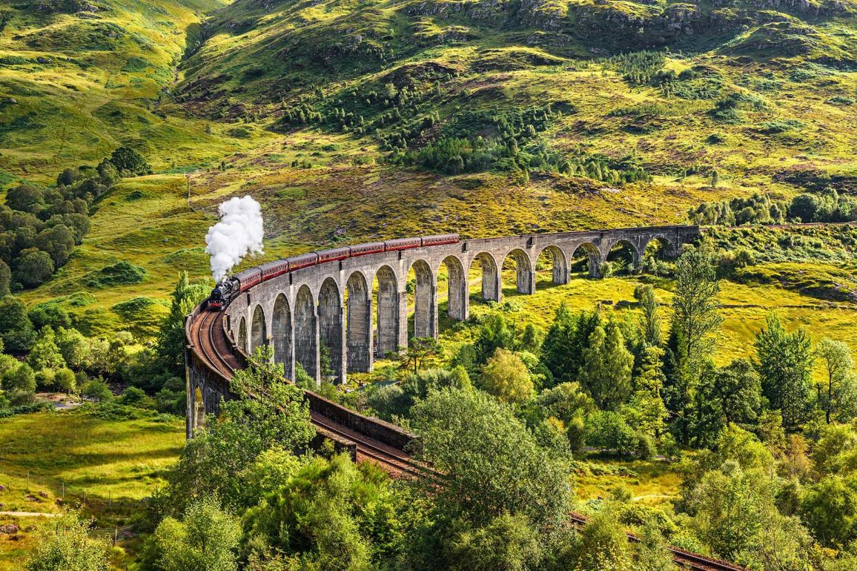 Glenfinnan Railway Viaduct in Scotland with the Jacobite steam train