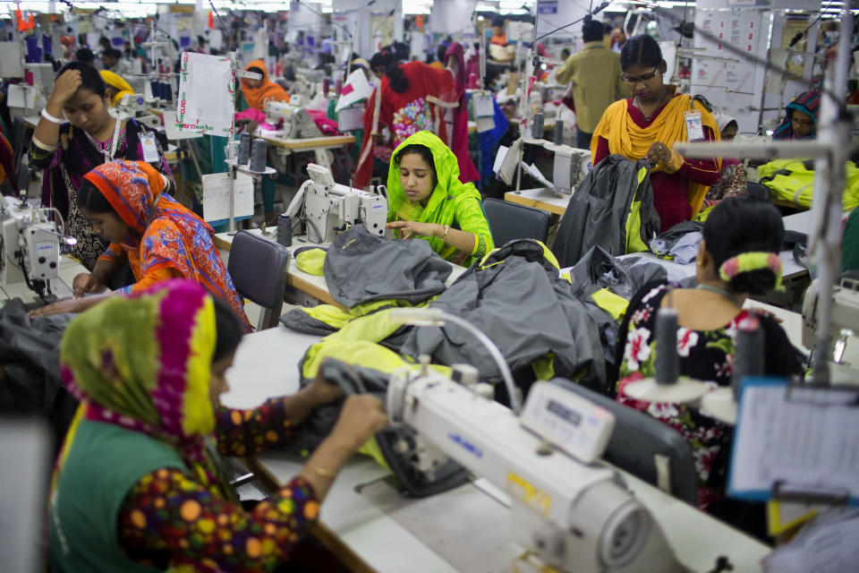 FILE - In this April 19, 2018 photo, Bangladeshis work at Snowtex garment factory in Dhamrai, near Dhaka, Bangladesh. A group set up by European clothing brands that has monitored factory safety in Bangladesh for years plans to leave, with its duties being assumed by a local group including unions and industry figures in the world's second-largest garment manufacturer. The European group and a separate North American group were formed after the collapse of Rana Plaza, a building housing five garment factories that made clothing for international brands. The departure, which officials said Thursday, Jan. 16, 2019, was planned for May, follows a protracted tussle with garment manufacturers who wanted Bangladesh's government to form a local watch group to monitor the sector. (AP Photo/A.M. Ahad, File)
