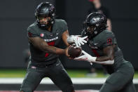 UNLV quarterback Cameron Friel (7) hands the ball off to running back Charles Williams (8) during the first half of an NCAA college football game against the Iowa State, Saturday, Sept. 18, 2021, in Las Vegas. (AP Photo/John Locher)