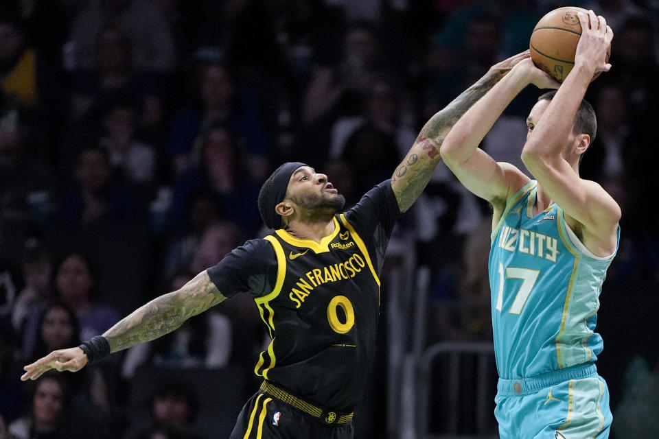 Charlotte Hornets forward Aleksej Pokusevski is fouled by Golden State Warriors guard Gary Payton II during the first half of an NBA basketball game on Friday, March 29, 2024, in Charlotte, N.C. (AP Photo/Chris Carlson)