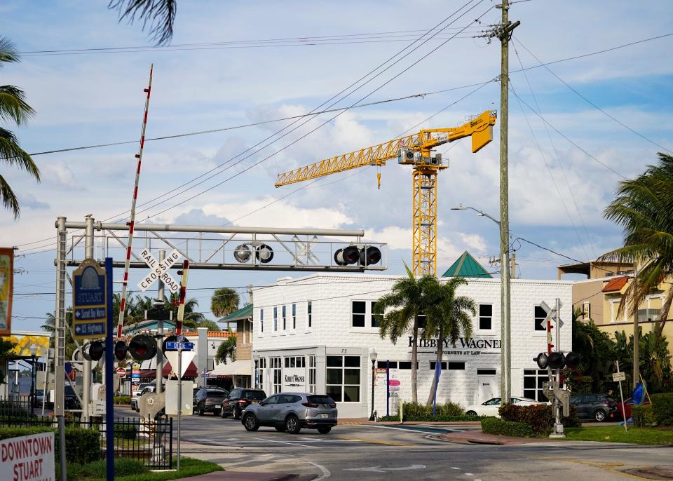 A tower crane is seen in downtown Stuart on Thursday, March 24, 2022. The crane has been a downtown fixture for nearly a year and is being used in the construction of a four-story condominium. The building's roofing and walls on the final level are expected to be complete in about a month.