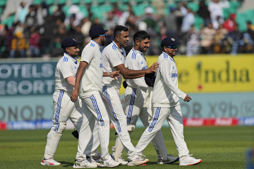 India's Kuldeep Yadav, right, is playfully pushed by teammate Ravichandran Ashwin as they leave the field at the end of England's inningson the first day of the fifth and final test match between England and India in Dharamshala, India, Thursday, March 7, 2024. (AP Photo/Ashwini Bhatia)