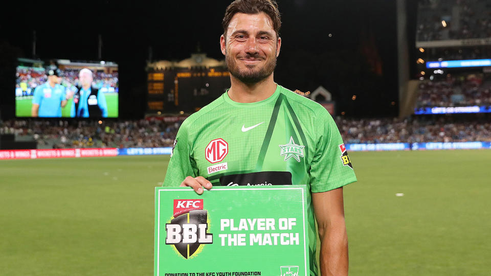 Marcus Stoinis holds up the BBL Player of the Match award.