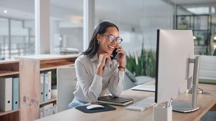 A financial advisor speaks with a client over the phone to give them an update on their account. 