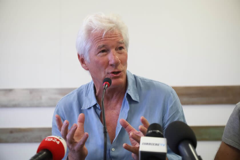 Actor Richard Gere gestures as he speaks during a press conference he held along with Open Arms founder Oscar Camps, in the island of Lampedusa, Southern Italy, Saturday, Aug. 10, 2019, the day after he visited the Spanish humanitarian ship that has been stuck at sea with 121 migrants on board for over a week, after Italy and Malta have denied it entry. The Open Arms boat has rescued 39 more migrants on Saturday morning. (AP Photo/Valerio Nicolosi)