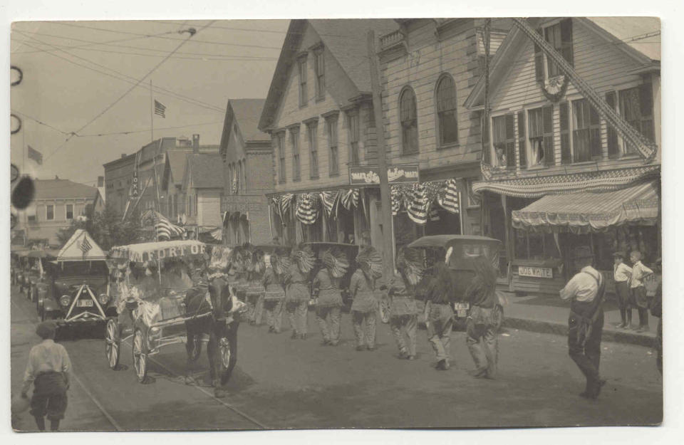 Exeter’s Carnival and Old Home Day parade was held on August 18th – just two weeks after the sudden death of President Warren Harding. This parade photo, taken on Water Street, shows the participants marching with the flag on the Ioka theater still at half-staff.